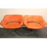 Two 1970's orange leather upholstered swivel chairs, size 81 x 66cm.