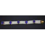 A boxed 18ct yellow gold (stamped 750) pearl bracelet set with cabochon cut lapis lazuli, L. 20cm.