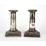 A pair of hallmarked silver candlesticks, H. 13cm.