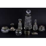 A group of silver topped items, a napkin ring and a snuff box.