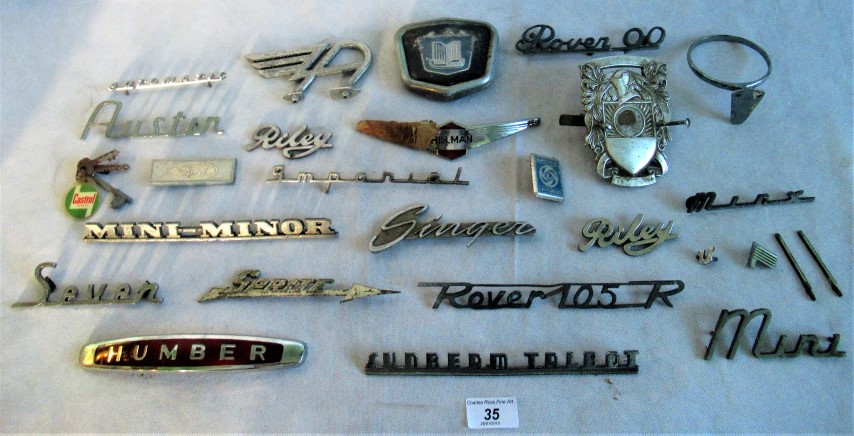 A collection of car badges, to include: Humber, Rover 90, Austin, Rover 105R, Riley,