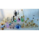 A large collection of glass perfume bottles, together with five glass mantle clocks.