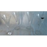 A set of four hand cut lead crystal champagne glasses, having tear drop pattern.