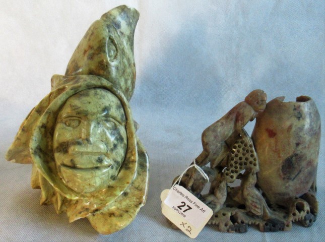 A soapstone bust of a monk and bird of prey, together with another soapstone.