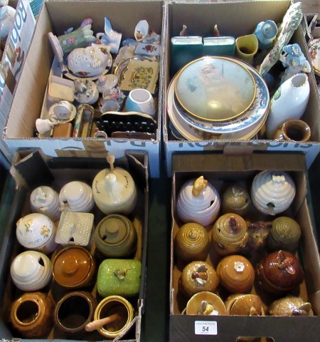 Two boxes containing a quantity of honey pots of various designs,