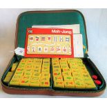 A Mahjong set in faux leather pouch.