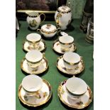 A Czechoslovakian tea service with gilt and fruit decoration, comprising: six cups, saucers, teapot,