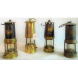 A Thomas & Williams miner's safety lamp, together with three other miner's lamps.