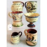 Six items of Devon Ware pottery.