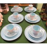 A quantity of Twin Tone Poole Pottery comprising: plates, saucers and coffee cups.