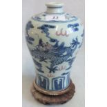 A Chinese blue & white porcelain Meiping vase with iron red detail of cavorting dragons and clouds.