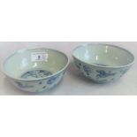 A pair of Chinese Qing dynasty blue & white rice bowls, decorated with clouds,