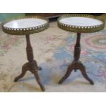 A pair of lamp tables, having brass gallery, inset marble top on tripod base.