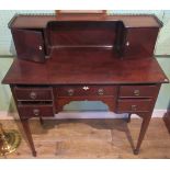 An Edwardian mahogany five drawer ladies writing desk with brass galleried super-structure.