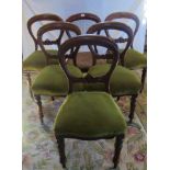 A set of six Victorian mahogany framed balloon back dining chairs with green draylon upholstered