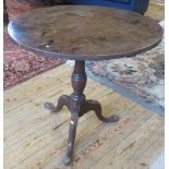 A Georgian oak tilt-top table.