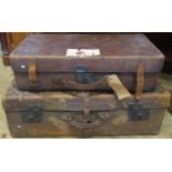 A set of three graduated full hide vintage suitcases.
