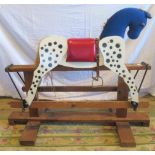 A small contemporary rocking horse on pine frame.