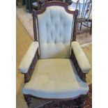 An Edwardian walnut framed and upholstered fireside chair.