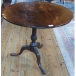 A 19th century oak tilt-top tripod table.