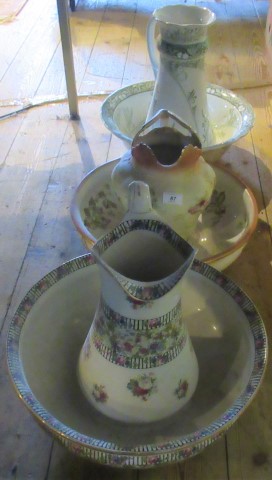 Three various decorated jugs and bowls.