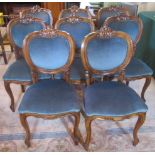 A set of eight reproduction mahogany framed and blue upholstered dining chairs.