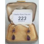 A pair of amethyst pendant earrings with claw mount,