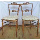 A pair of Victorian walnut framed cane seated bedroom chairs.