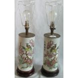 A pair of Oriental table lamps with foliage and Bird of Paradise decoration.