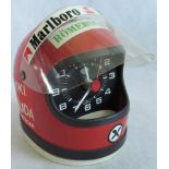 A Heuer Niki Lauder helmet desk clock.