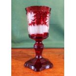 A Bohemian ruby flashed chalice, having etched panoramic forest scene.