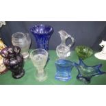 A collection of eight various items of coloured glass, to include: claret jug,