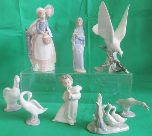 A collection of eight various Lladro and Nao figurines.