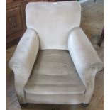 A large Edwardian fireside chair, upholstered in champagne draylon.