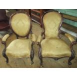 Two Victorian walnut framed cameo back and upholstered fireside chairs.