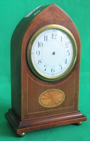 An Edwardian mahogany and shell inlaid mantle clock.