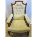 An Edwardian walnut framed and upholstered fireside chair.