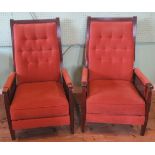 A pair of mid-20th century mahogany framed reclining chairs in salmon draylon upholstery and cane