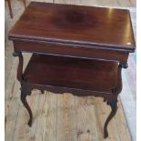 An Edwardian mahogany two tier swivel top card table.