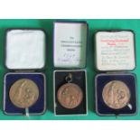 A collection of three gardening medals.