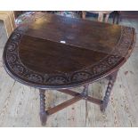 An Edwardian carved oak barley twist gate-leg drop flap dining table.