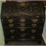 A 19th century profusely carved oak bureau.