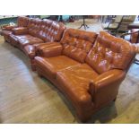 A contemporary curved tan leather lounge suite, comprising: three seater settee, two seater sofa,