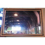 A contemporary gilt framed and painted wall mirror.