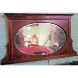 An Edwardian mahogany and satinwood strung overmantle, with oval bevel plate.