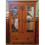 An Edwardian satinwood wardrobe, having two mirrored doors over single drawer.