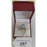 A blue topaz dress ring, the rectangular mixed cut stone in an engraved claw mount,