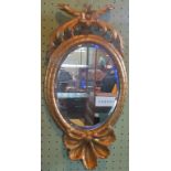 A 19th century gilt wood and gesso oval wall mirror, with shell mount.