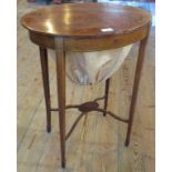 An Edwardian mahogany oval work table.