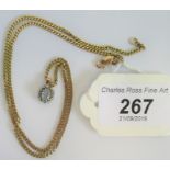 A 9 carat gold aquamarine pendant, with a border of small diamonds,